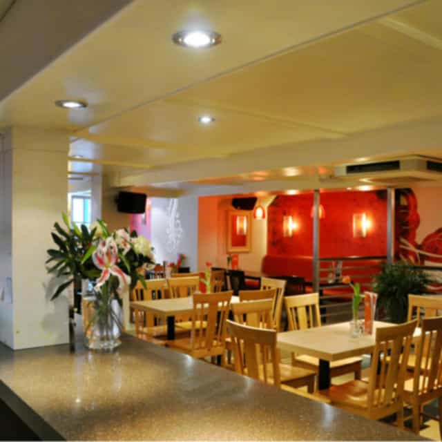 Cozy private meeting room with modern decor at Rendezvous Wine Bar. Ideal for small events.