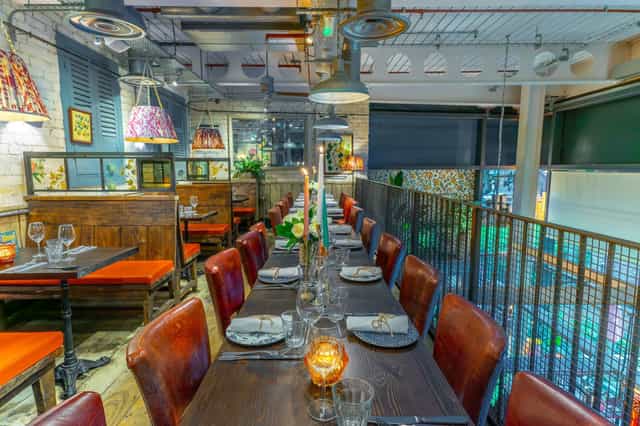 Cozy dining area at Bill's Exeter with a long wooden table, ideal for intimate events.