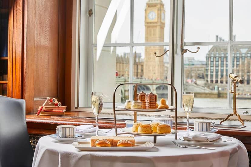 Elegant table with pastries and champagne at The Silly Goose, featuring Big Ben view.