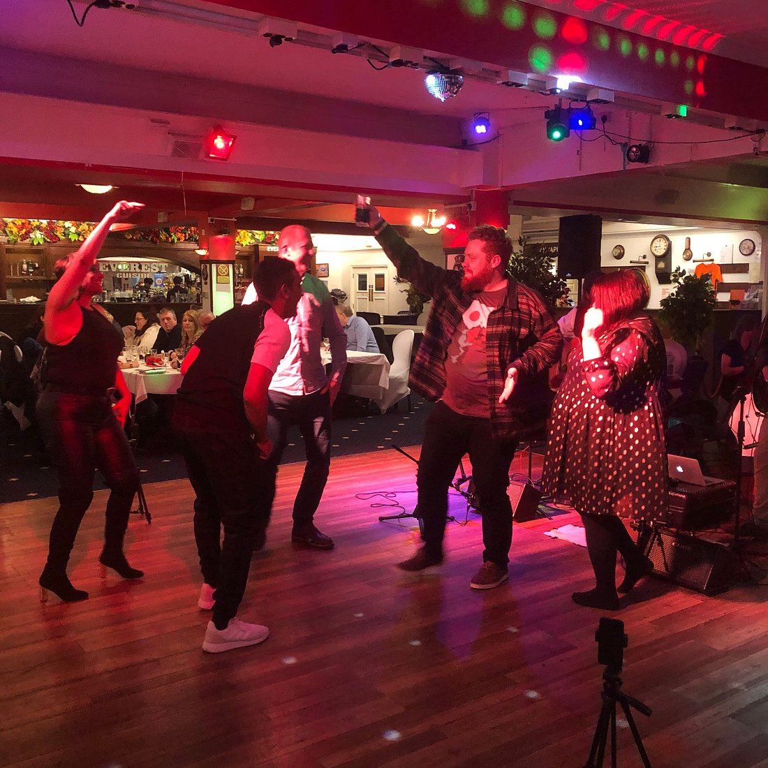 Main Hall & Dance Floor at Everest Cuisine during a lively social event with vibrant lighting.