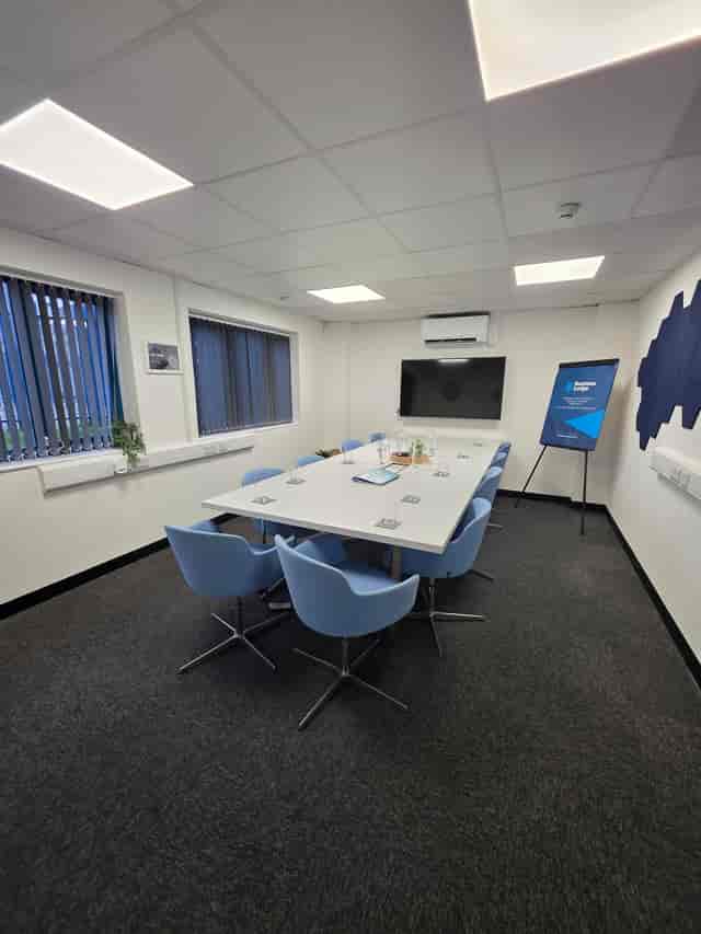Modern meeting room with blue chairs, ideal for corporate events and workshops.