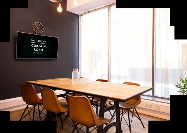 Modern meeting room with large table in Boutique Workplace, ideal for workshops and presentations.