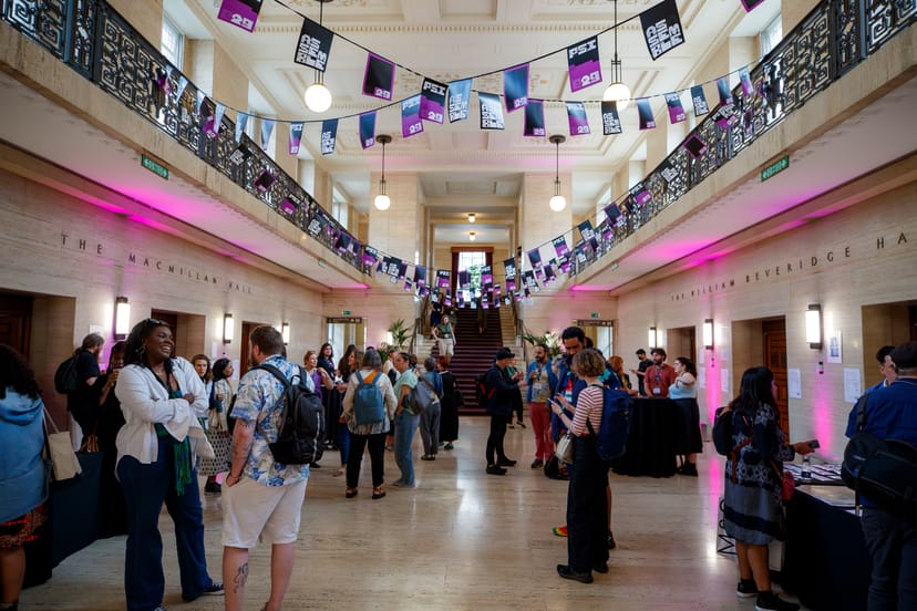 Beveridge Hall event space with attendees networking under decorative bunting.