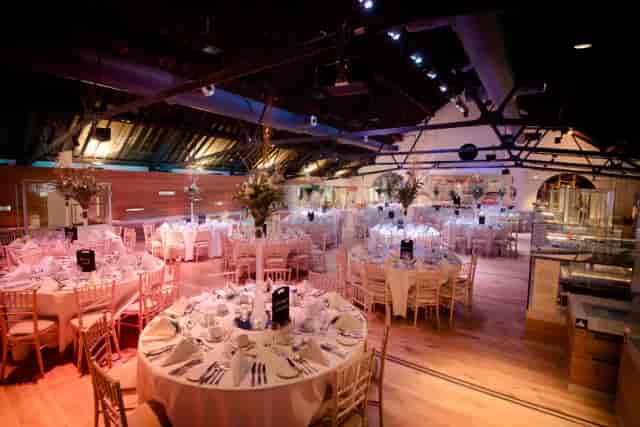 Elegant round tables in the Warehouse Gallery, ideal for upscale weddings and corporate events.
