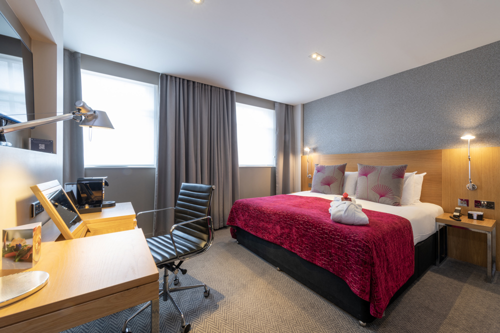 Hotel bedroom in Apex Temple Court with ergonomic workspace, perfect for business events.