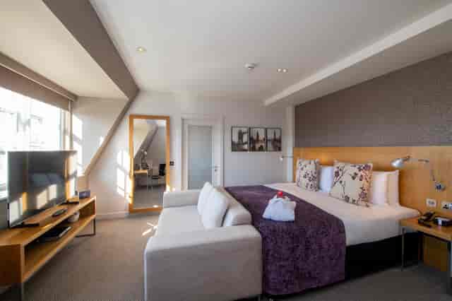 Apex Temple Court Hotel spacious room with modern decor for events and meetings.