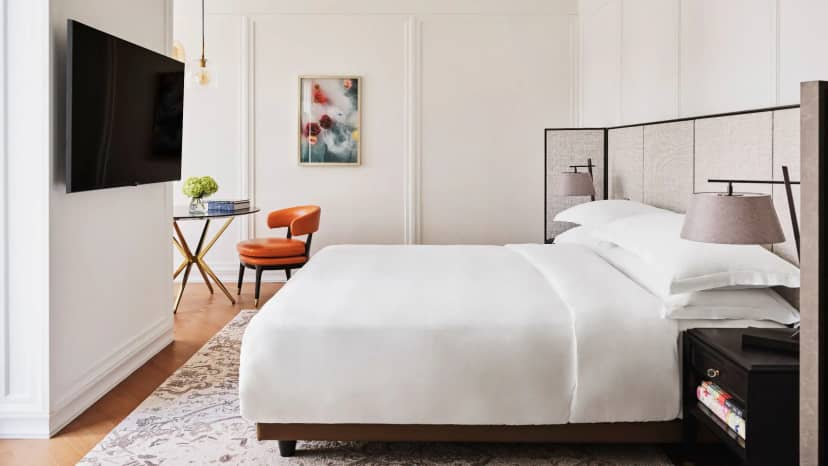 Modern luxury hotel bedroom with workstation, ideal for executive retreats and VIP events.