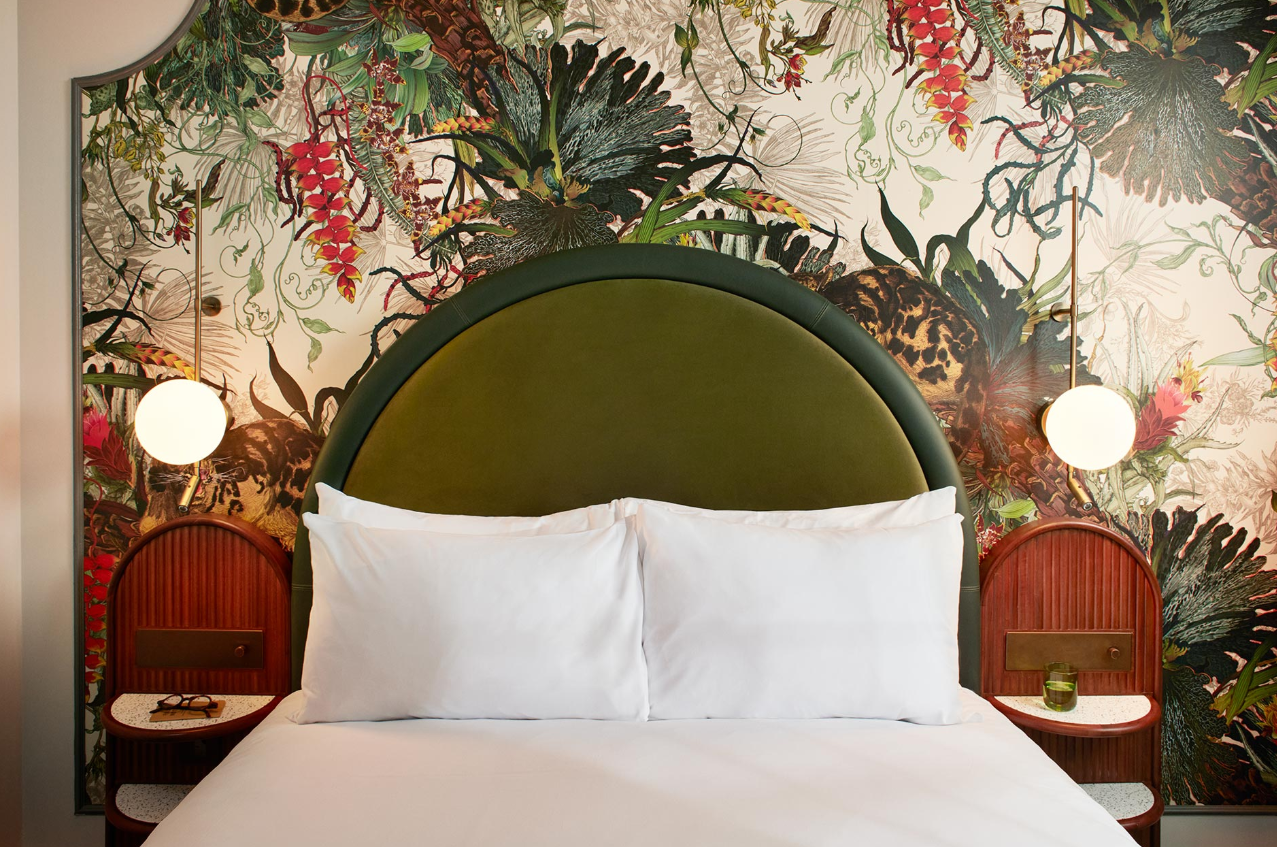 Stylish hotel room with botanical wallpaper, ideal for retreats and meetings in London. - Banner