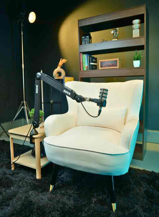 Podcast recording studio with a professional microphone and cozy armchair in London.
