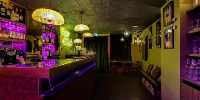 Vibrant Le Cancan Pigalle venue with neon lights, ideal for cocktail receptions and gatherings.