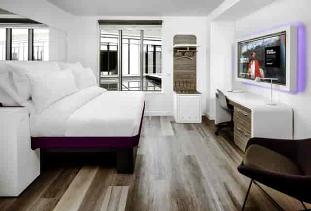 Modern Yotel London City hotel room with workspace, ideal for business travel and remote work.