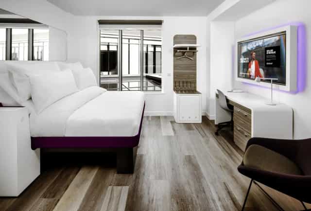 Modern Yotel London City hotel room with workspace, ideal for business travel and remote work.