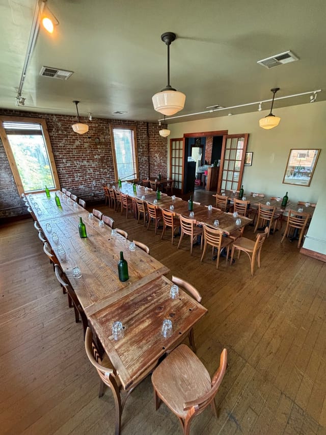 Spacious Second Floor Event Space at Firehouse Restaurant with rustic wooden tables.