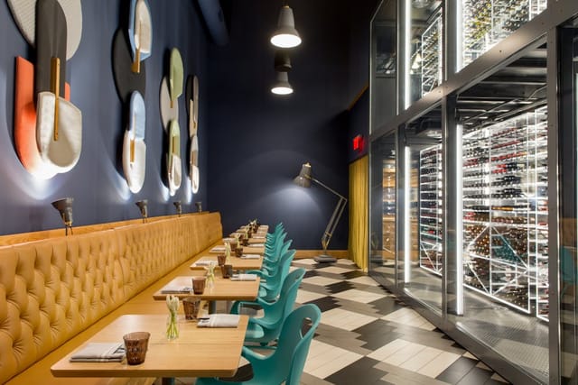 Modern dining space at Enoteca Alto with stylish wine display for networking events.