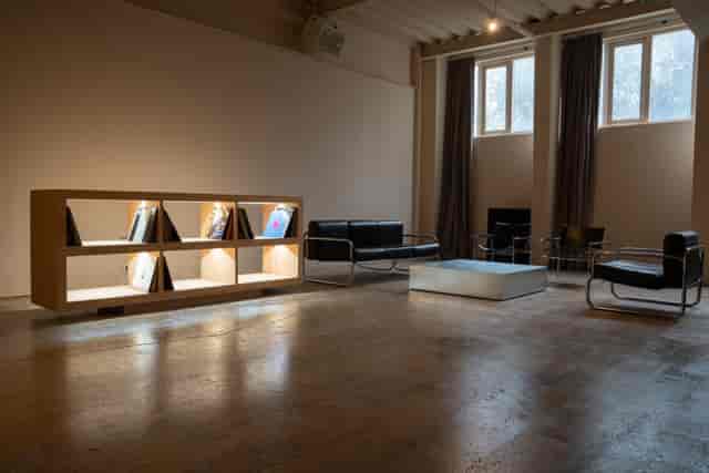 Minimalist meeting space in London photography studio with sleek furniture and soft lighting.