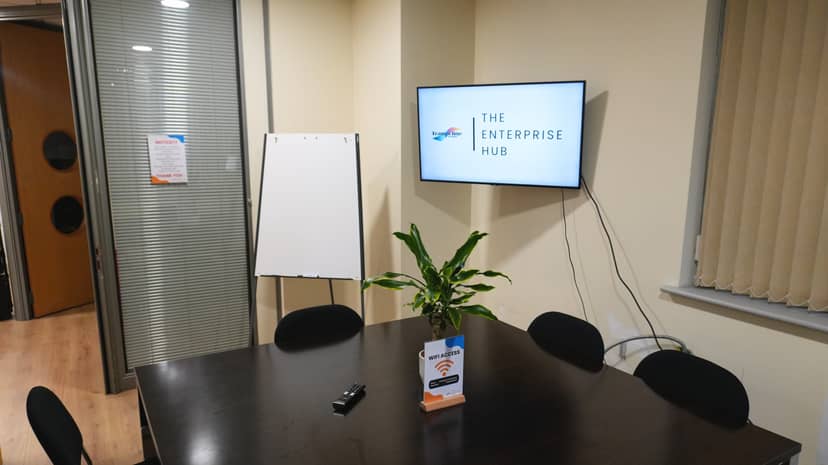 Orange Room breakout space with AV and flipchart for collaborative planning and team meetings.