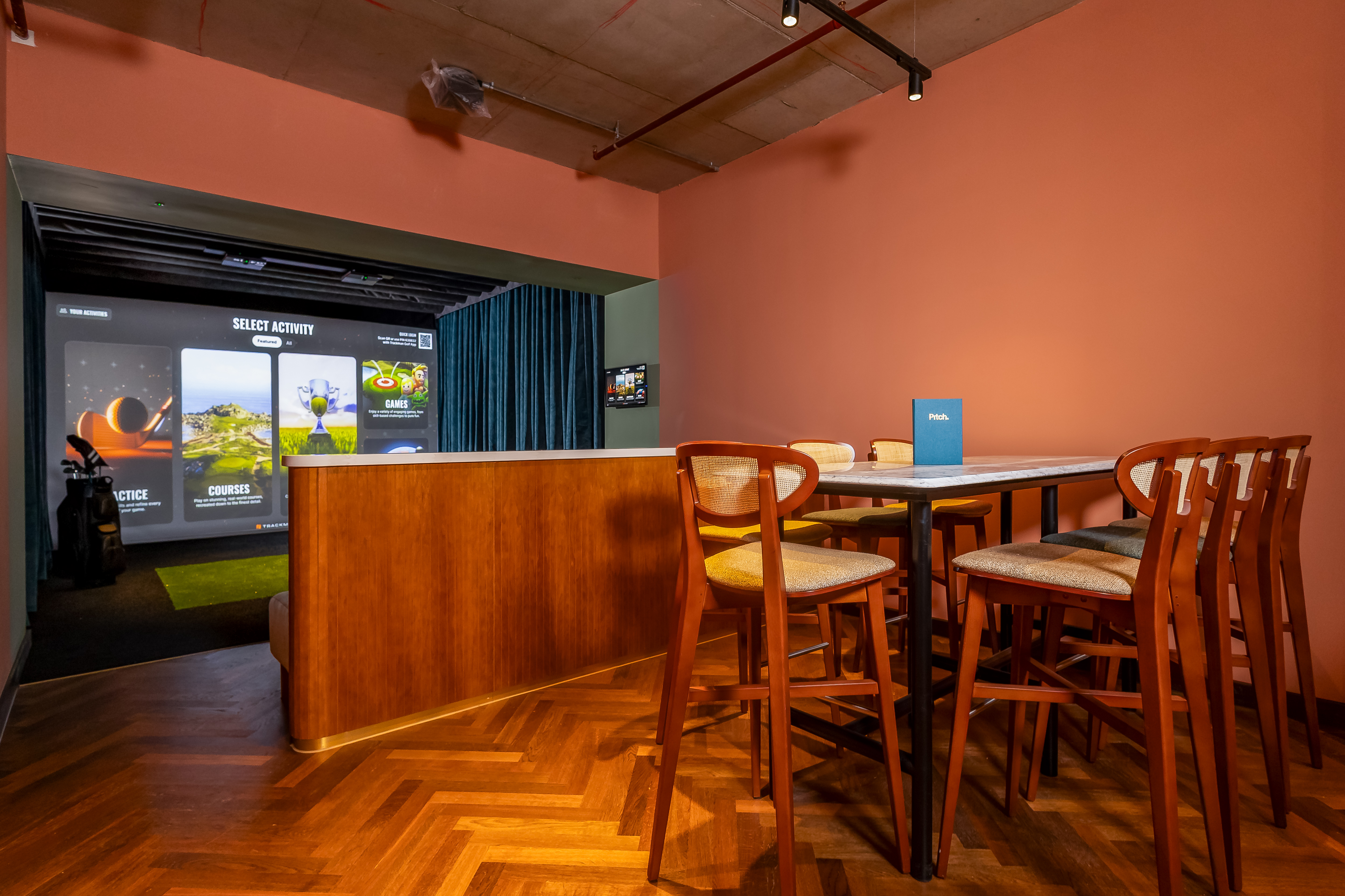 Modern meeting space in Pitch Golf Manchester with stylish seating for interactive events.