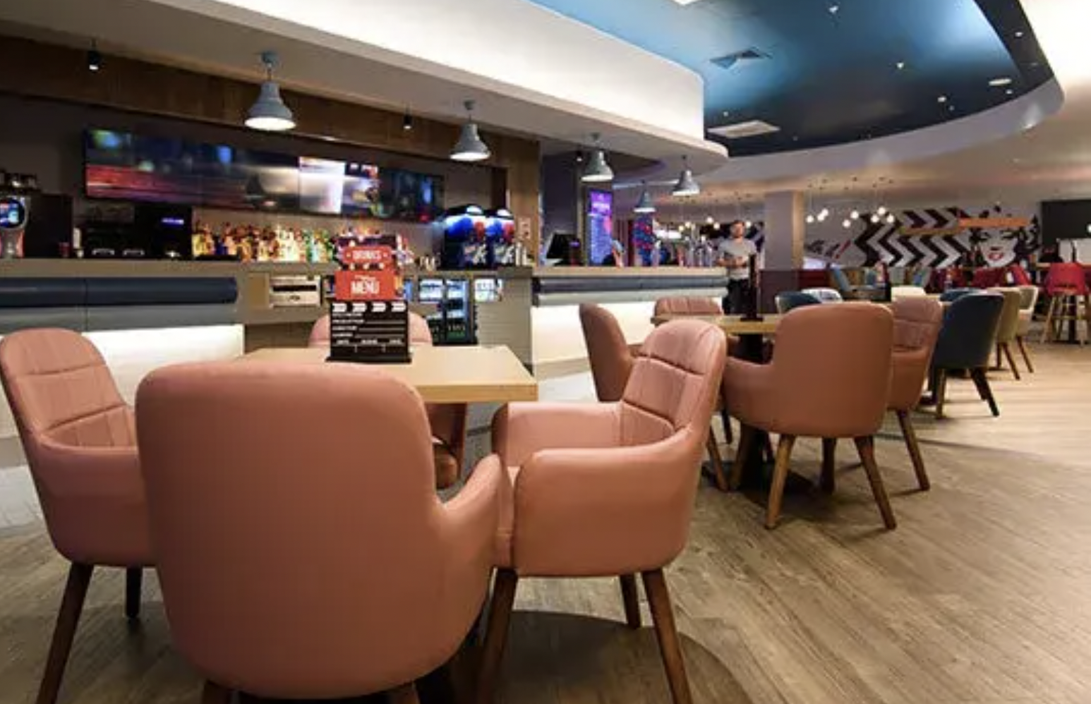 Modern event space at Hollywood Bowl Birmingham with pink chairs for networking and meetings.