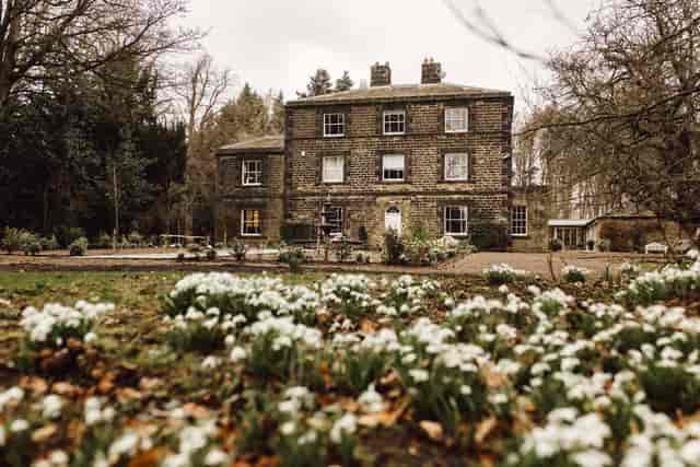 Coach House & Manor venue with stone architecture, ideal for events and meetings.