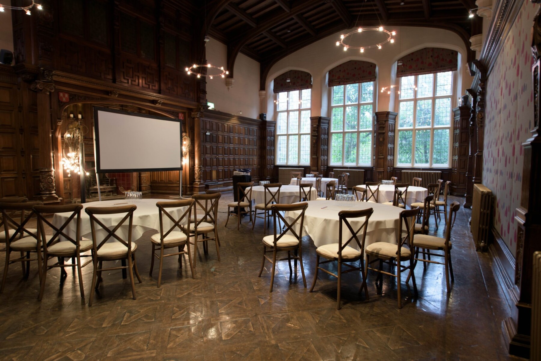 Historic wood-paneled Great Hall at Jesmond Dene House set for banquet wedding event.