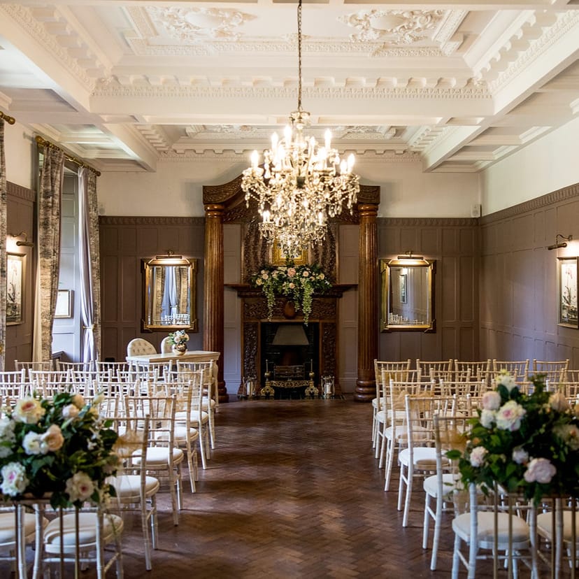 Olive House wedding ceremony at Ellingham Hall with elegant floral decor and theater seating.