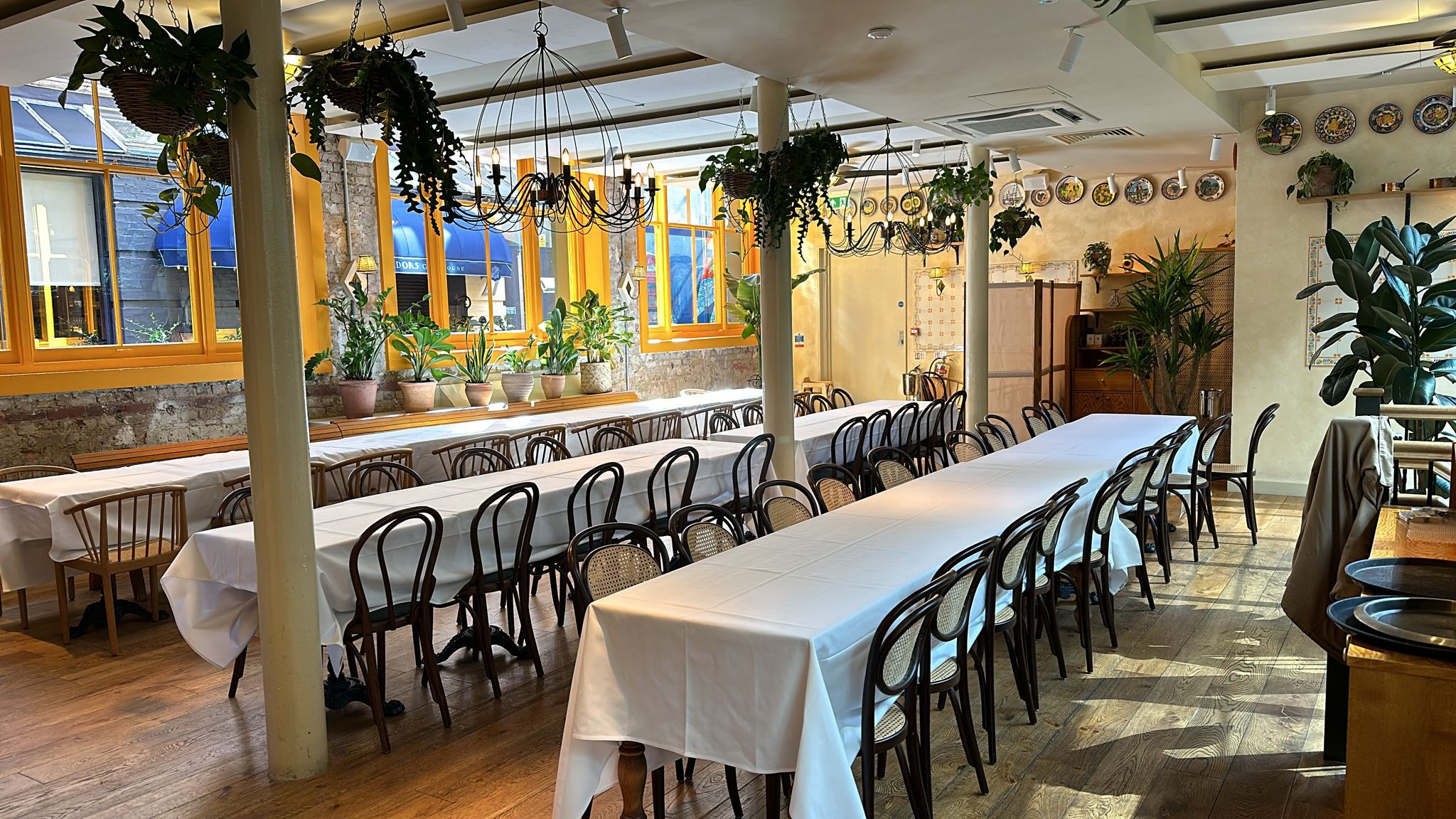 Garden Side restaurant hire with long tables, ideal for events and gatherings.