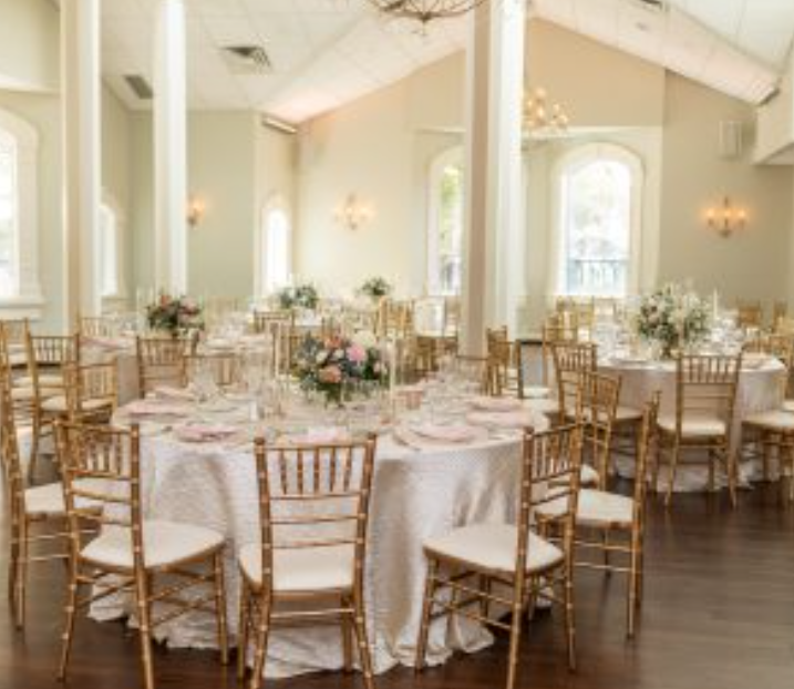 Elegant ballroom gala dinner set with gold Chiavari chairs for corporate events and weddings.
