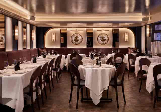 Sophisticated restaurant interior with elegant table settings for corporate events.