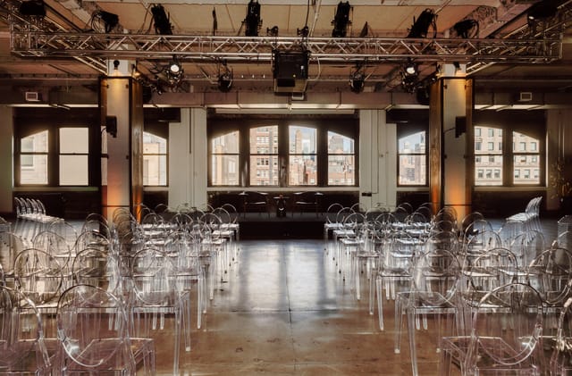 District Lounge event space with acrylic chairs, ideal for conferences and performances.