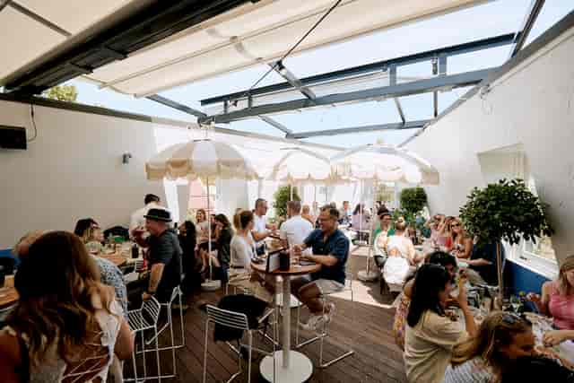 Vibrant Sydney rooftop venue with casual seating for summer social events