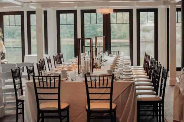 Banquet-style table at The Field Lounge venue featuring scenic waterfront views for event planning.