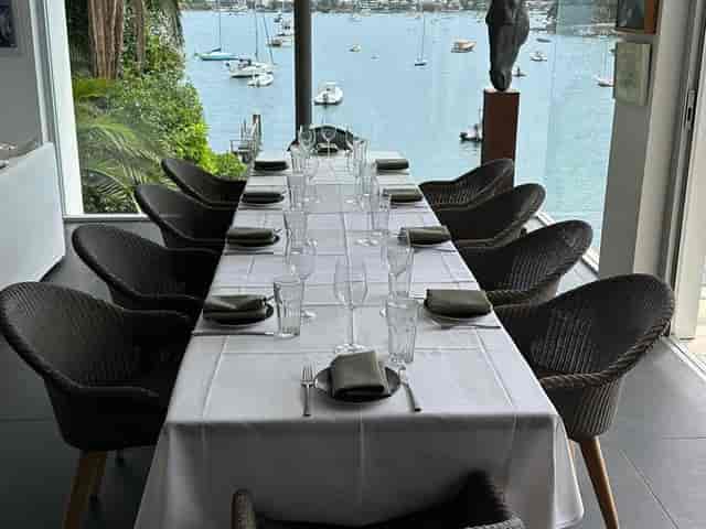 Elegant long table setup at Figo Restaurant Bar for upscale events by waterfront.