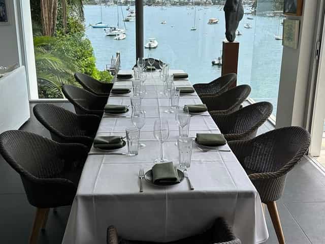Elegant long table setup at Figo Restaurant Bar for upscale events by waterfront.