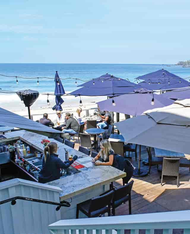 Oceanfront corporate cocktail mixer at Watsons Bay Hotel with ambient string lighting.