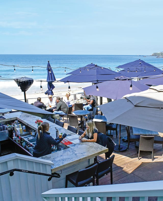 Oceanfront corporate cocktail mixer at Watsons Bay Hotel with ambient string lighting.