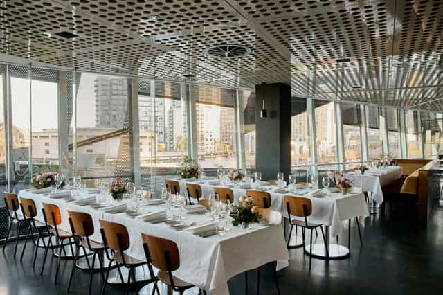 Elegant dining area with city view in Transit Rooftop Bar for upscale events.