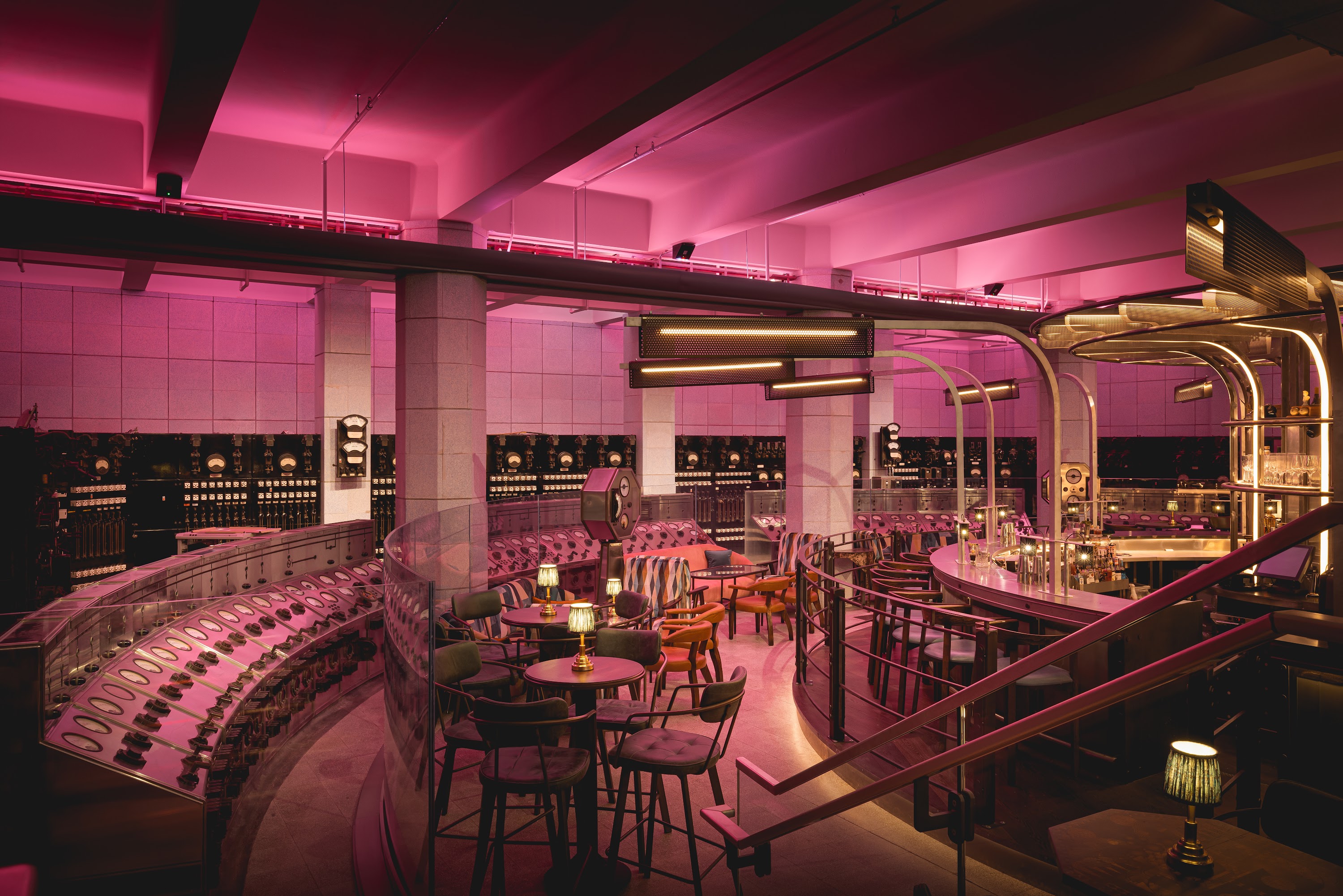 Semi private event space for 31-120 guests with stylish seating and vibrant lighting.