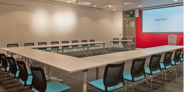 Flexible U-shaped meeting space in Coram Conference Centre for workshops and presentations.