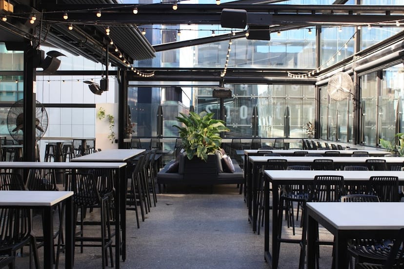 Main Room rooftop venue with string lights for corporate cocktail receptions and networking events.
