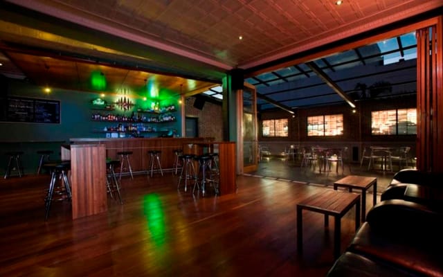 Badlands Bar Main Room: Versatile indoor-outdoor event space for networking and cocktail parties.