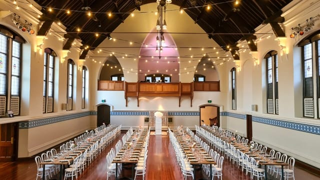 Banquet setup in Perth Town Hall, featuring bistro lighting for historic event venue hire.