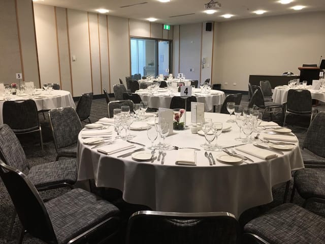 Banquet hall with round tables for corporate events and social gatherings at University Club.