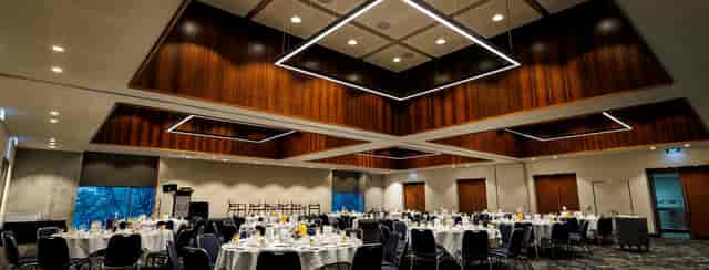 Elegant ballroom with geometric lighting for upscale corporate gala dinners and social events.