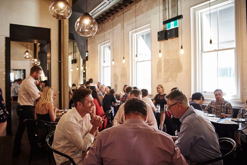 Industrial-chic event venue with bistro seating for corporate mixers and networking events.