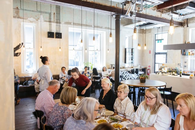 Industrial-chic networking luncheon with communal seating for corporate events.