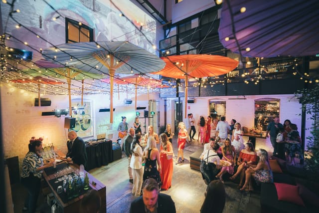 Long Chim courtyard evening reception with string lighting for corporate events and gala catering.