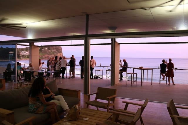 Sunset oceanfront reception in Avalon Beach SLSC club room for corporate events and weddings.
