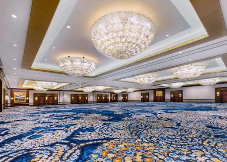 Elegant ballroom with chandeliers in Hilton Americas Houston for corporate events.