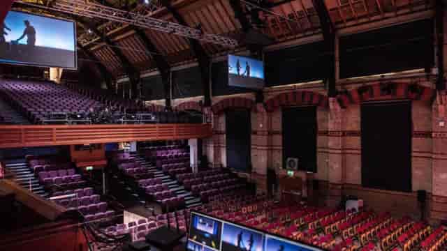 Cambridge Corn Exchange auditorium with tiered seating, ideal for corporate events and conferences.