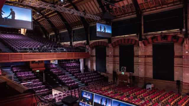 Cambridge Corn Exchange auditorium with tiered seating, ideal for corporate events and conferences.